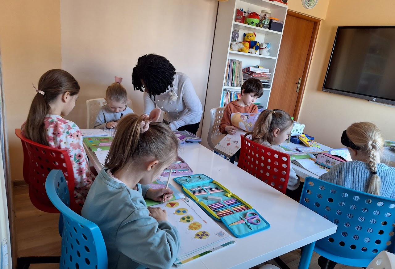A group of young children working on an English lesson at Open Doors Strzelin